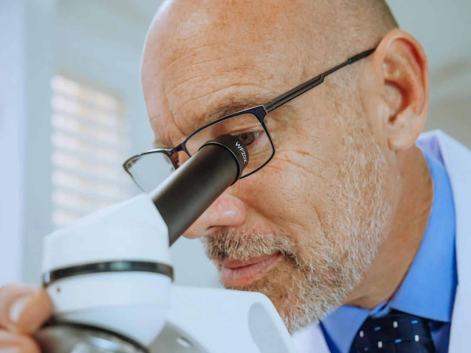 What changes for men over 40: Scientist using a microscope for research in a laboratory setting.