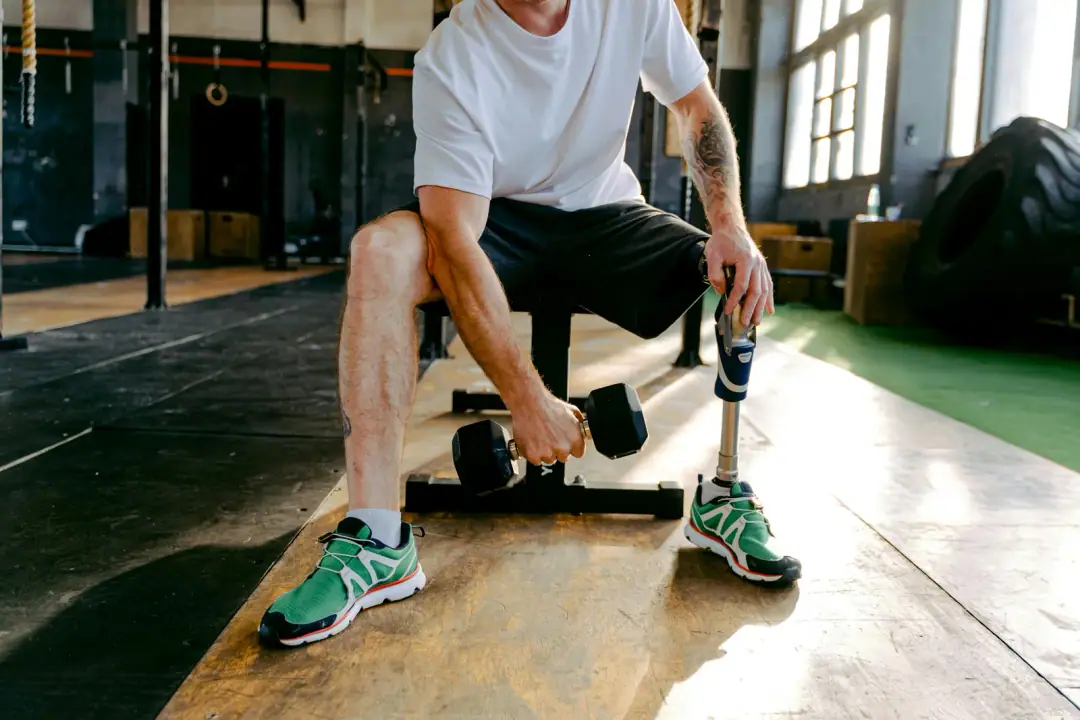 Safety: what's known and what isn't: An adult male with a prosthetic leg exercises in a gym, focusing on strength training and fitness.