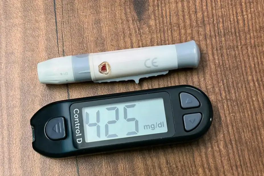 What to actually look for: A glucometer displaying high glucose reading of 425 mg/dL, essential for diabetes care.