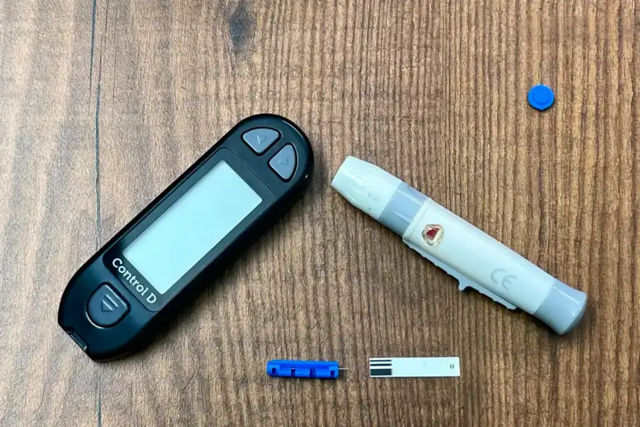 What to pair it with: Close-up of a diabetes monitoring kit with glucometer and lancing device on a wooden surface.