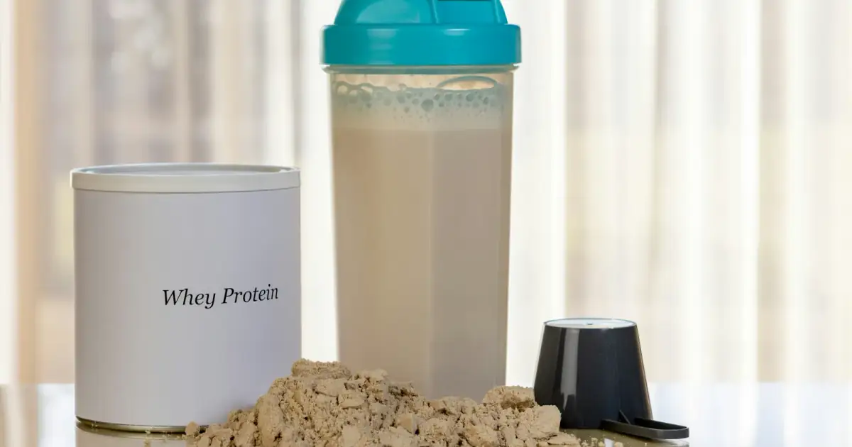 Whey protein powder with shaker bottle and scoop