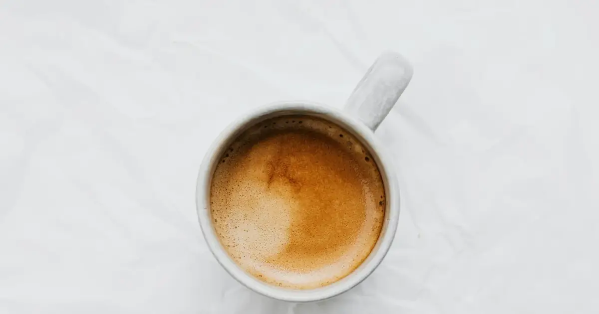 Aerial view of a coffee cup on a white background. Ideal for food and beverage themes.