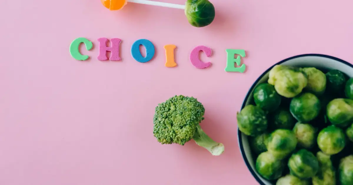 Colorful depiction of healthy and sweet food choices on pink backdrop.