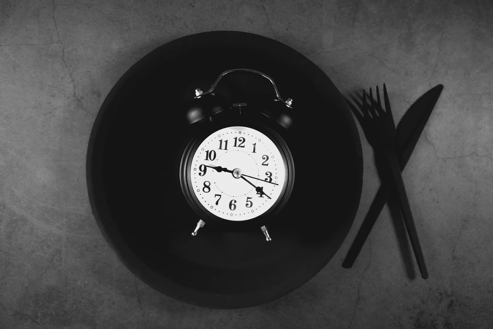 The clock genes and why timing matters at all: Alarm clock on a plate with cutlery