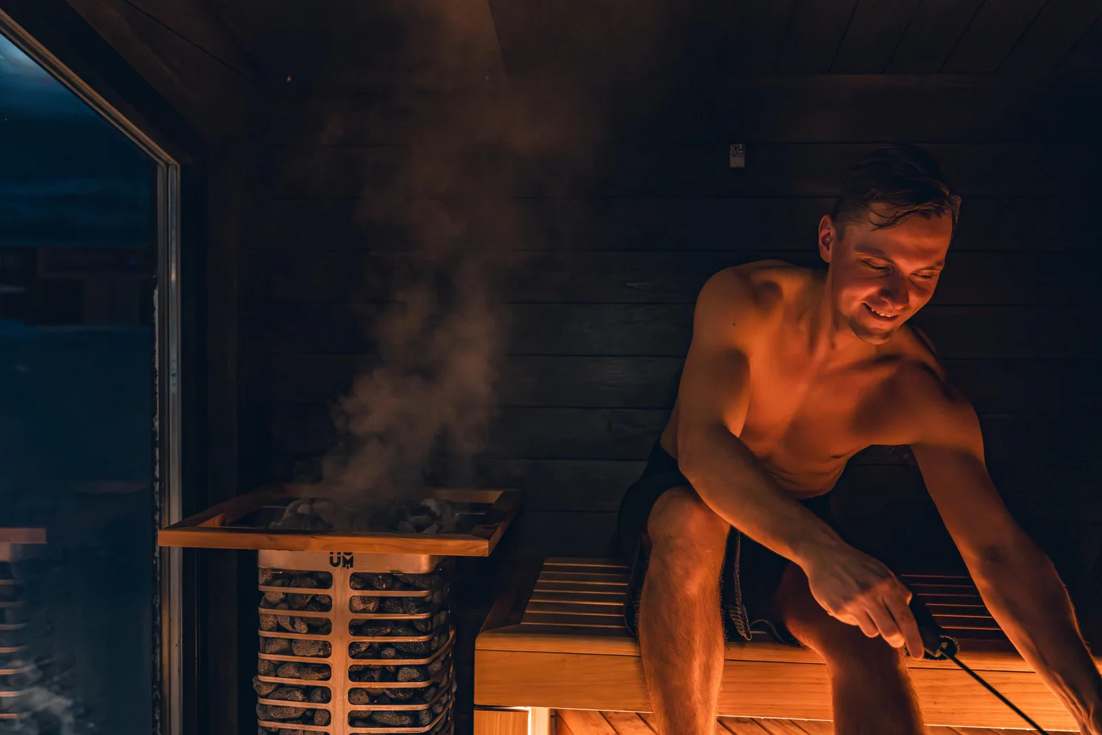 What's observational about this, and what it means: A man enjoying a warm and relaxing sauna session, embracing Nordic design.