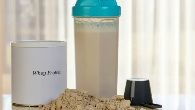 Whey protein powder with shaker bottle and scoop