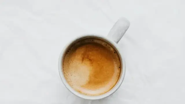 Aerial view of a coffee cup on a white background. Ideal for food and beverage themes.