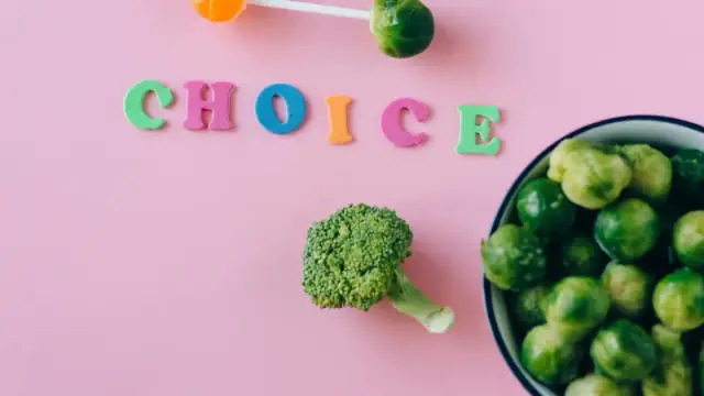 Colorful depiction of healthy and sweet food choices on pink backdrop.