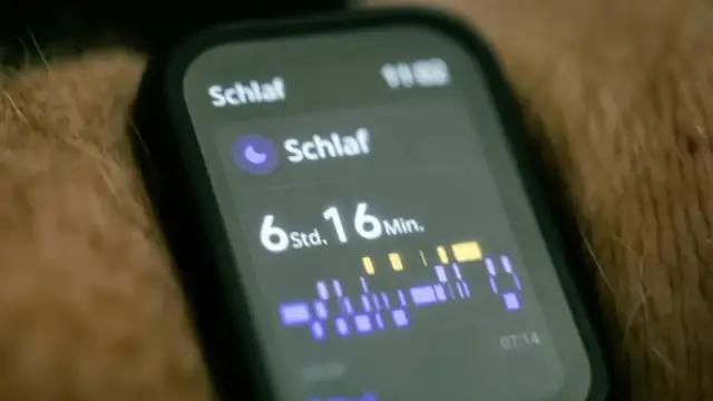 Close-up of a smartwatch displaying sleep tracking data in German.